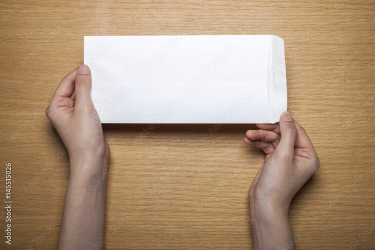 manos sosteniendo una carta sobre mesa wooden